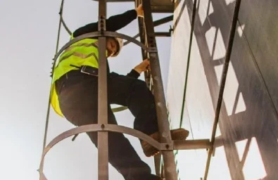 worker climbing on side of building
