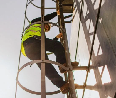 worker climbing on side of building