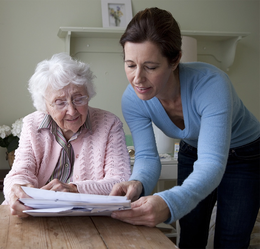 two ladies at a table reading